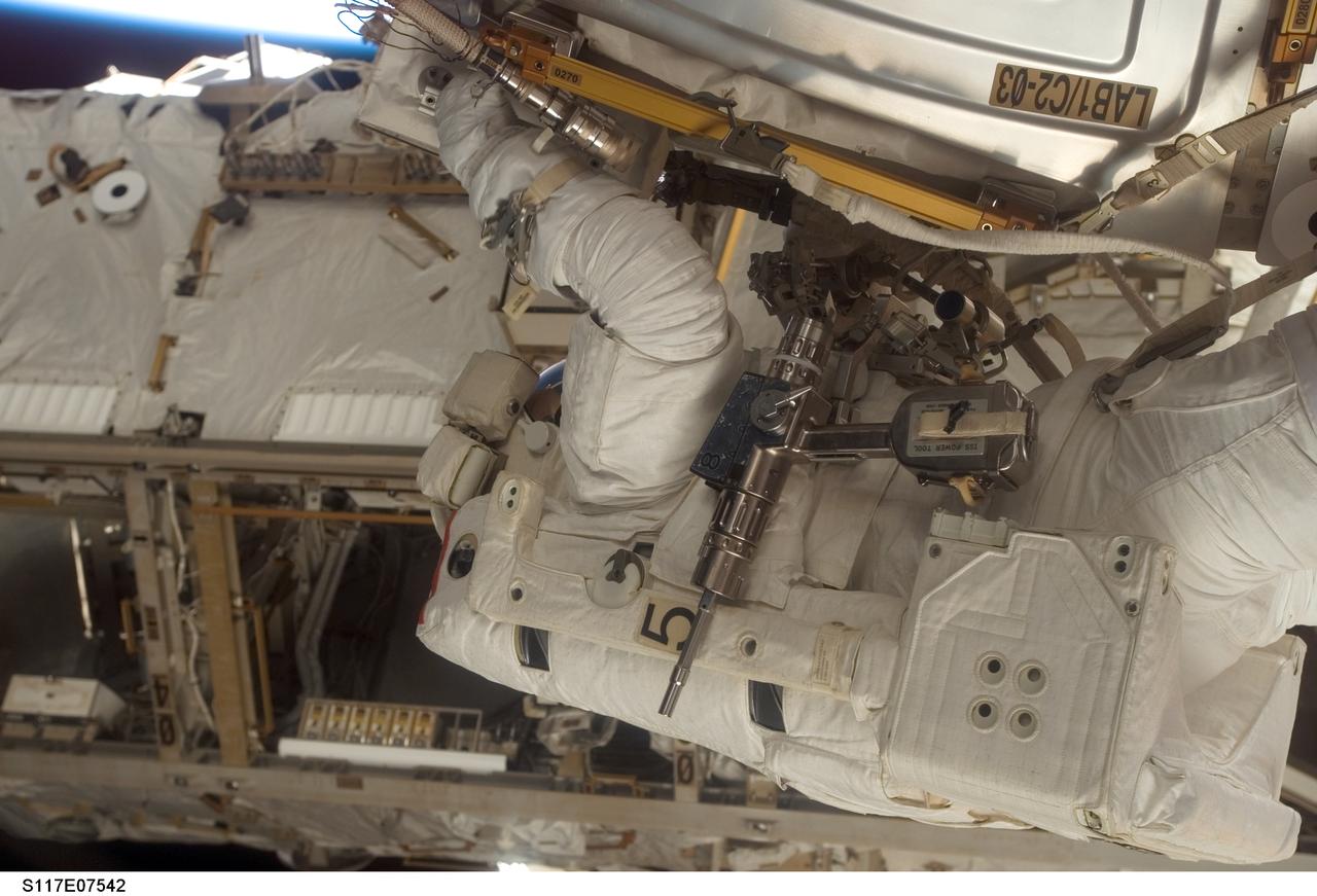 S117-E-07542 (15 June 2007) --- Astronaut Jim Reilly is photographed by a crewmate inside the spacecraft in the midst of a 7 hour, 58-minute spacewalk. Astronauts Reilly and John (Danny) Olivas (out of frame), both STS-117 mission specialists, each performed solo and shared tasks on their second and the mission's third extravehicular activity.