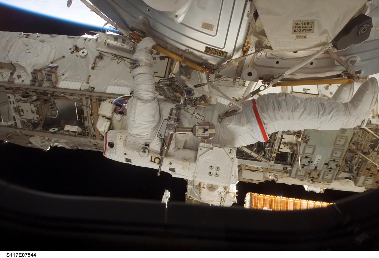 S117-E-07544 (15 June 2007) --- Astronaut Jim Reilly is photographed by a crewmate inside the spacecraft in the midst of a 7 hour, 58-minute spacewalk. Astronauts Reilly and John (Danny) Olivas (out of frame), both STS-117 mission specialists, each performed solo and shared tasks on their second and the mission's third extravehicular activity.  Reilly is holding onto a handrail on the Destiny lab.