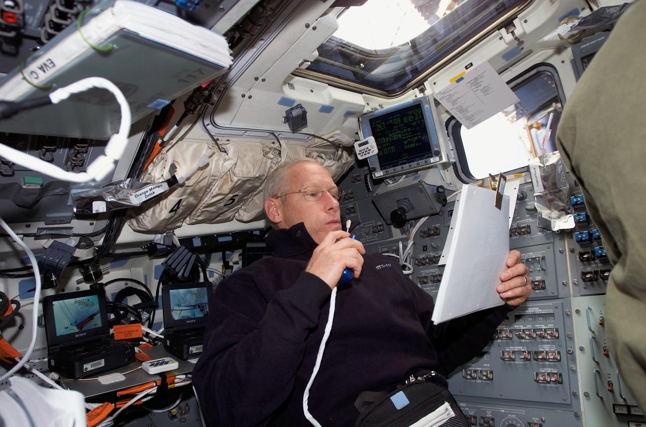 S117-E-07595 (15 June 2007) --- On the aft flight deck of the Space Shuttle Atlantis, astronaut Patrick Forrester, STS-117 mission specialist, talks to ground controllers while supporting two spacewalking crewmates. Forrester will participate in the fourth and final STS-117 spacewalk on June 17.