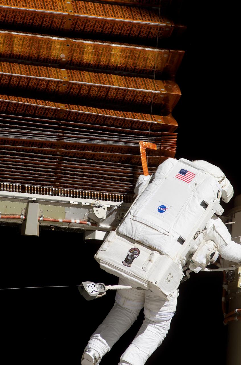 S117-E-07612 (15 June 2007) --- Astronaut John "Danny" Olivas uses a homemade "hockey stick" tool to fluff a solar array panel during the 7-hour and 58-minute spacewalk he performed with astronaut Jim Reilly on June 15. The two mission specialists had several tasks to perform, all of which they completed successfully. After working on separate tasks, the two astronauts joined forces with their colleagues inside the shuttle and station and flight controllers in Houston to complete the delicate process of folding an older solar array so that it can be moved from its temporary location to its permanent home during a shuttle mission this fall.