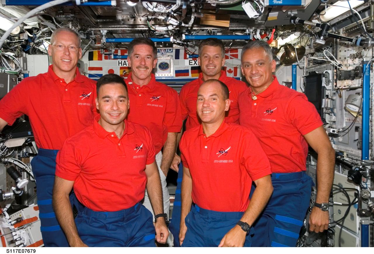 S117-E-07679 (16 June 2007) --- The STS-117 crewmembers gather for a group portrait during a joint crew press conference in the Destiny laboratory of the International Space Station while Space Shuttle Atlantis was docked with the station. From the left (front row) are astronauts Lee Archambault and Rick Sturckow, pilot and commander, respectively. From the left (back row) are astronauts Patrick Forrester, Jim Reilly, Steven Swanson and John "Danny" Olivas, all mission specialists.