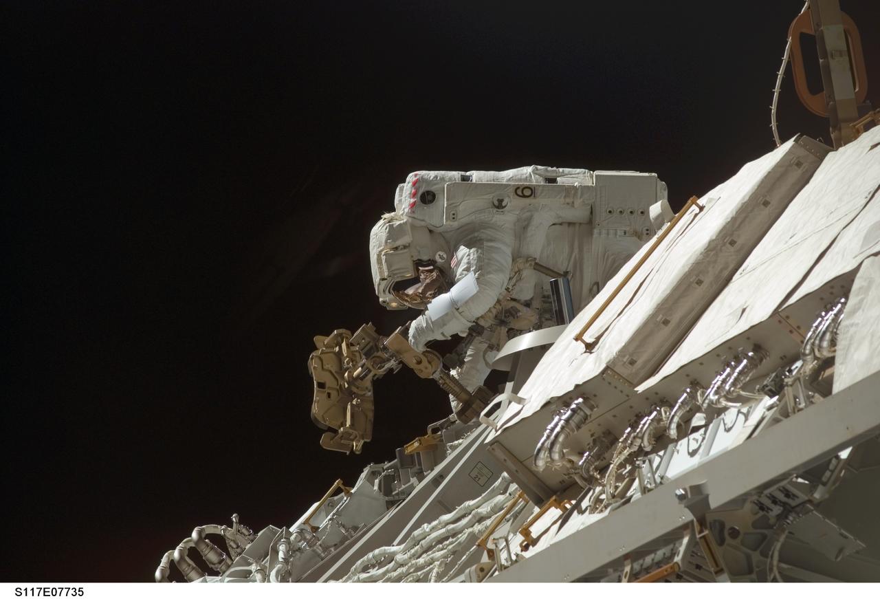 S117-E-07735 (17 June 2007) --- Astronaut Steven Swanson, STS-117 mission specialist, participates in the mission's fourth and final session of extravehicular activity (EVA), as construction continues on the International Space Station. Among other tasks, Swanson and astronaut Patrick Forrester (out of frame), mission specialist, continued activation of the station's new starboard 3 and 4 (S3/S4) truss segment; checked out the Drive Lock Assembly 2, one of two mechanisms that will drive rotation of the S3/S4 Truss Solar Alpha Rotary Joint (SARJ); and removed the final launch restraints on the SARJ.