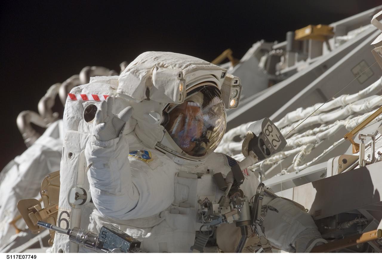 S117-E-07749 (17 June 2007) --- Astronaut Steven Swanson, STS-117 mission specialist, participates in the mission's fourth and final session of extravehicular activity (EVA), as construction continues on the International Space Station. Among other tasks, Swanson and astronaut Patrick Forrester (out of frame), mission specialist, continued activation of the station's new starboard 3 and 4 (S3/S4) truss segment; checked out the Drive Lock Assembly 2, one of two mechanisms that will drive rotation of the S3/S4 Truss Solar Alpha Rotary Joint (SARJ); and removed the final launch restraints on the SARJ.