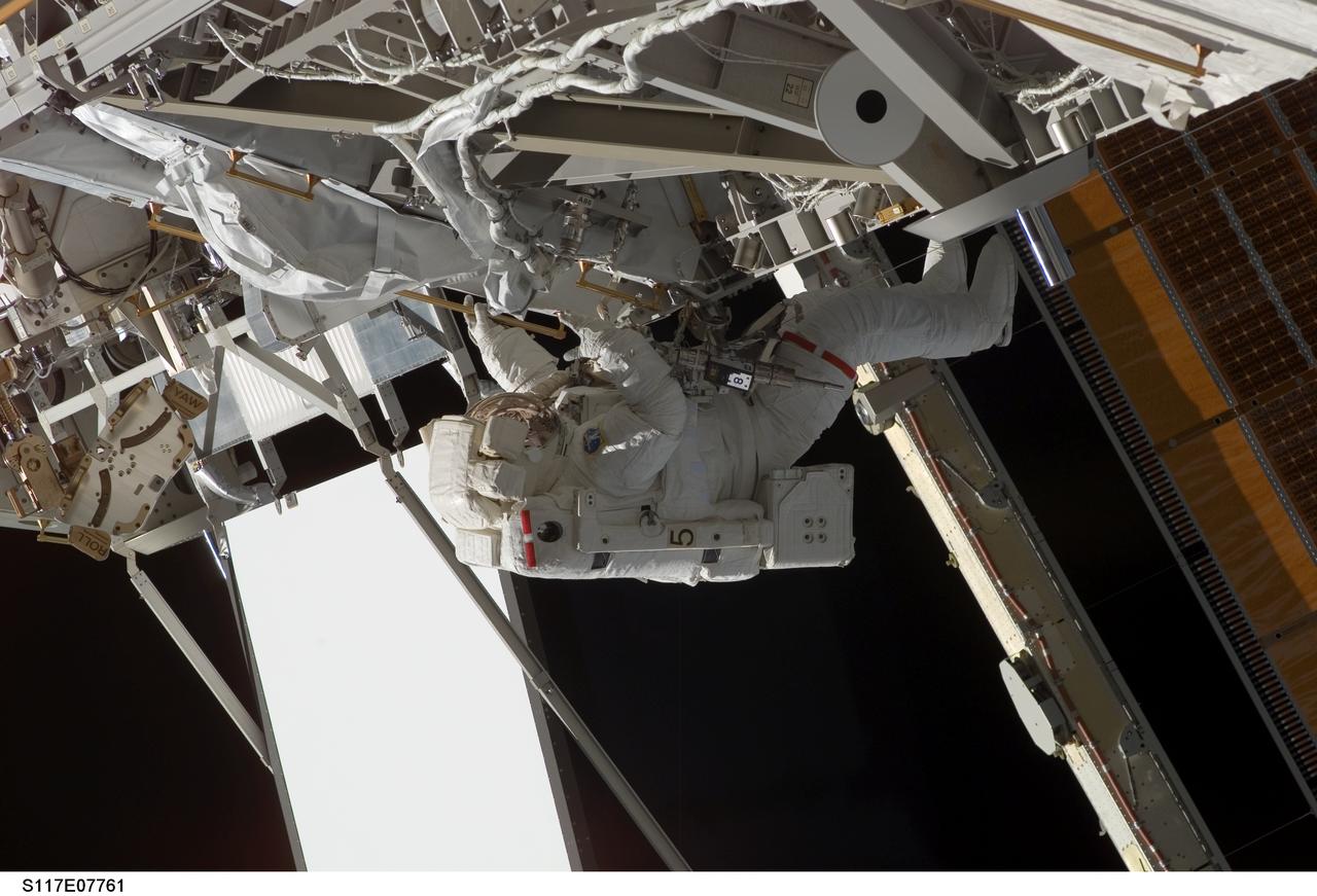 S117-E-07761 (17 June 2007) --- Astronaut Patrick Forrester, STS-117 mission specialist, participates in the mission's fourth and final session of extravehicular activity (EVA), as construction continues on the International Space Station. Among other tasks, Forrester and astronaut Steven Swanson (out of frame), mission specialist, continued activation of the station's new starboard 3 and 4 (S3/S4) truss segment; checked out the Drive Lock Assembly 2, one of two mechanisms that will drive rotation of the S3/S4 Truss Solar Alpha Rotary Joint (SARJ); and removed the final launch restraints on the SARJ.