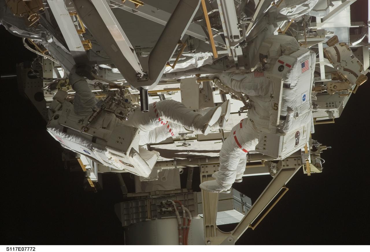 S117-E-07772 (17 June 2007) --- Astronauts Patrick Forrester (right) and Steven Swanson, both STS-117 mission specialists, participate in the mission's fourth and final session of extravehicular activity (EVA), as construction continues on the International Space Station. Among other tasks, Forrester and Swanson continued activation of the station's new starboard 3 and 4 (S3/S4) truss segment; checked out the Drive Lock Assembly 2, one of two mechanisms that will drive rotation of the S3/S4 Truss Solar Alpha Rotary Joint (SARJ); and removed the final launch restraints on the SARJ.