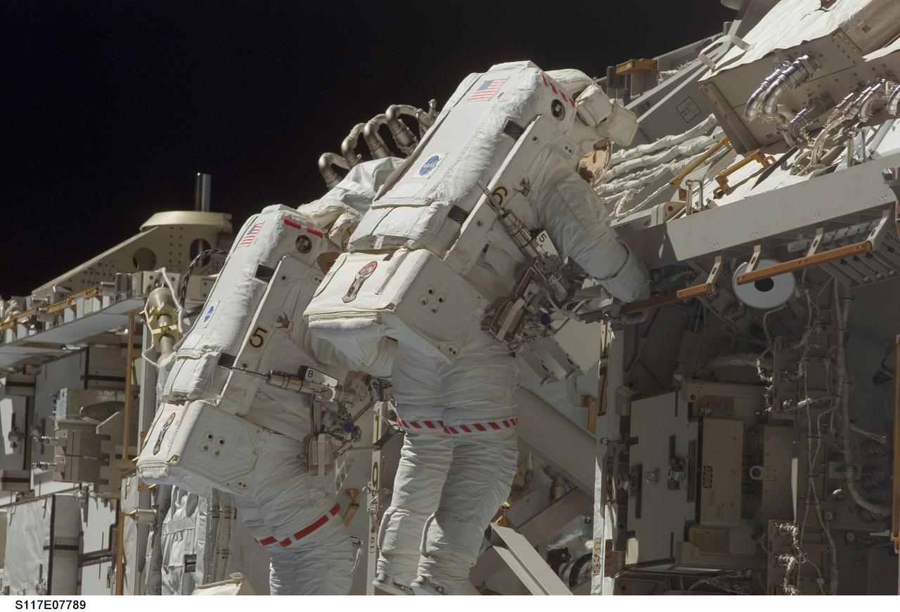 S117-E-07789 (17 June 2007) --- Astronauts Patrick Forrester (left) and Steven Swanson, both STS-117 mission specialists, participate in the mission's fourth and final session of extravehicular activity (EVA), as construction continues on the International Space Station. Among other tasks, Forrester and Swanson continued activation of the station's new starboard 3 and 4 (S3/S4) truss segment; checked out the Drive Lock Assembly 2, one of two mechanisms that will drive rotation of the S3/S4 Truss Solar Alpha Rotary Joint (SARJ); and removed the final launch restraints on the SARJ.