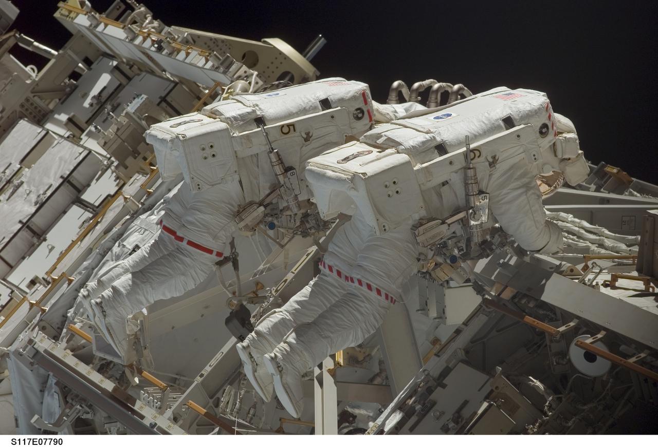 S117-E-07790 (17 June 2007) --- Astronauts Patrick Forrester (left) and Steven Swanson, both STS-117 mission specialists, participate in the mission's fourth and final session of extravehicular activity (EVA), as construction continues on the International Space Station. Among other tasks, Forrester and Swanson continued activation of the station's new starboard 3 and 4 (S3/S4) truss segment; checked out the Drive Lock Assembly 2, one of two mechanisms that will drive rotation of the S3/S4 Truss Solar Alpha Rotary Joint (SARJ); and removed the final launch restraints on the SARJ.