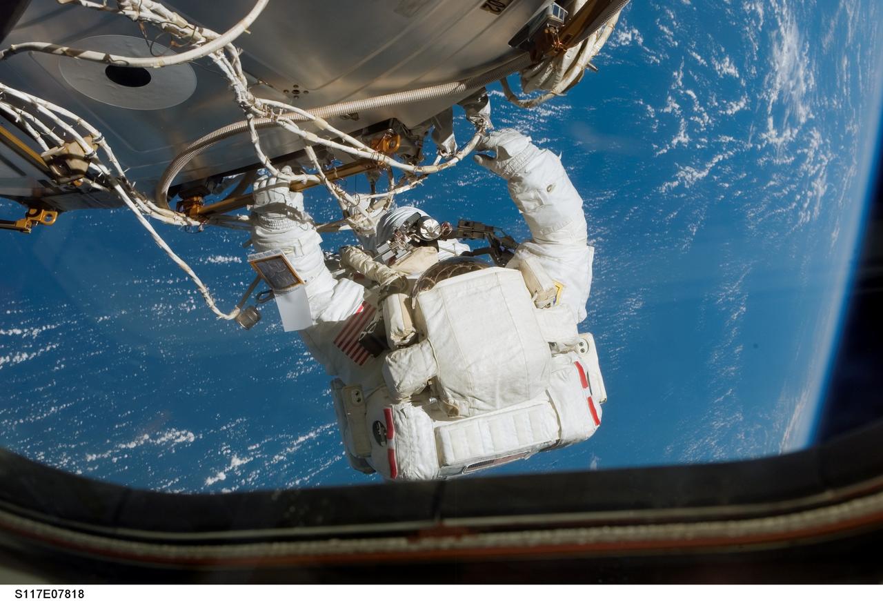 S117-E-07818 (17 June 2007) --- Astronaut Patrick Forrester, STS-117 mission specialist, participates in the mission's fourth and final session of extravehicular activity (EVA), as construction continues on the International Space Station. Among other tasks, Forrester and astronaut Steven Swanson (out of frame), mission specialist, continued activation of the station's new starboard 3 and 4 (S3/S4) truss segment; checked out the Drive Lock Assembly 2, one of two mechanisms that will drive rotation of the S3/S4 Truss Solar Alpha Rotary Joint (SARJ); and removed the final launch restraints on the SARJ.