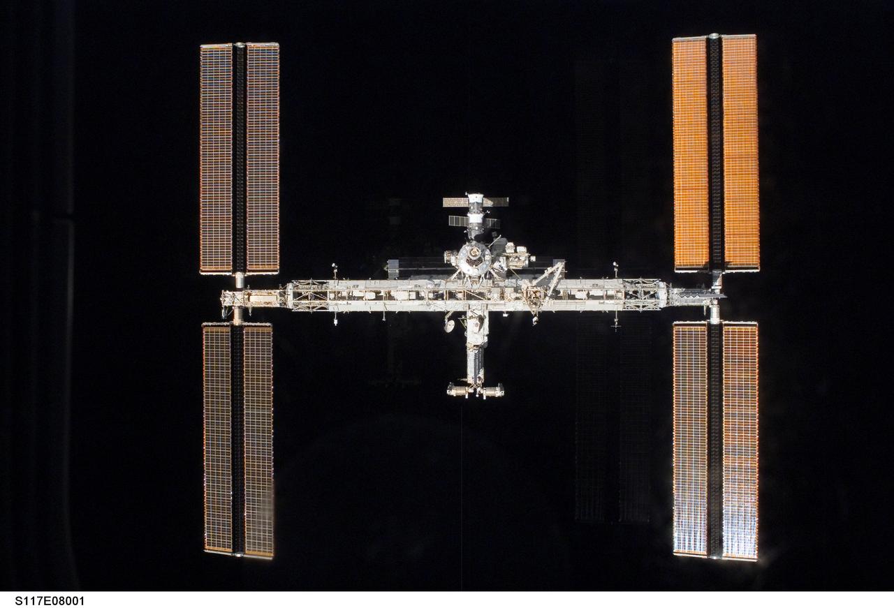S117-E-08001 (19 June 2007) --- Backdropped by the blackness of space, the International Space Station moves away from the Space Shuttle Atlantis. Earlier the STS-117 and Expedition 15 crews concluded about eight days of cooperative work onboard the shuttle and station. Undocking of the two spacecraft occurred at 9:42 a.m. (CDT) on June 19, 2007. Astronaut Lee Archambault, STS-117 pilot, was at the controls for the departure and fly-around, which gave Atlantis' crew a look at the station's new expanded configuration.