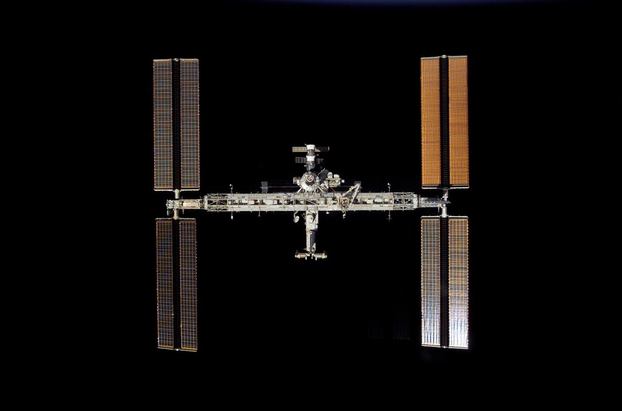 S117-E-08731 (19 June 2007) --- Backdropped by the blackness of space, the International Space Station moves away from the Space Shuttle Atlantis. Earlier the STS-117 and Expedition 15 crews concluded about eight days of cooperative work onboard the shuttle and station. Undocking of the two spacecraft occurred at 9:42 a.m. (CDT) on June 19, 2007. Astronaut Lee Archambault, STS-117 pilot, was at the controls for the departure and fly-around, which gave Atlantis' crew a look at the station's new expanded configuration.
