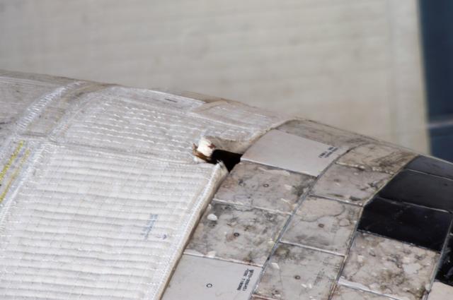 NASA image: Damaged thermal blanket noted on port OMS Pod on STS-117 Space Shuttle Atlantis