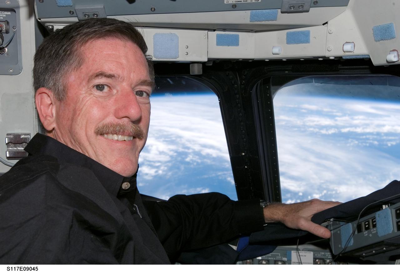 S117-E-09045 (19 June 2007) --- Astronaut Jim Reilly, STS-117 mission specialist, occupies the commander's station on the flight deck of Space Shuttle Atlantis during flight day 12 activities.