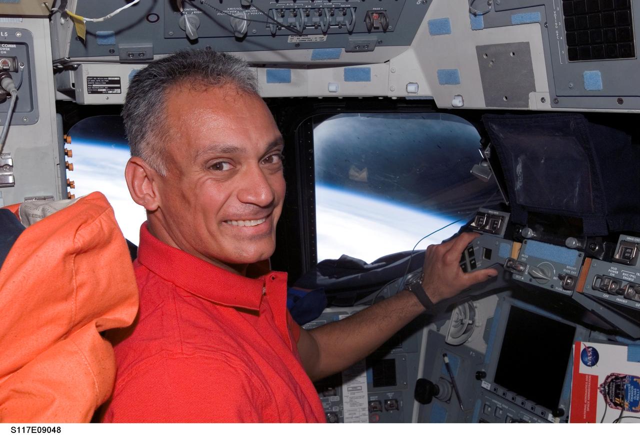 S117-E-09048 (19 June 2007) --- Astronaut John "Danny" Olivas, STS-117 mission specialist, occupies the commander's station on the flight deck of Space Shuttle Atlantis during flight day 12 activities.
