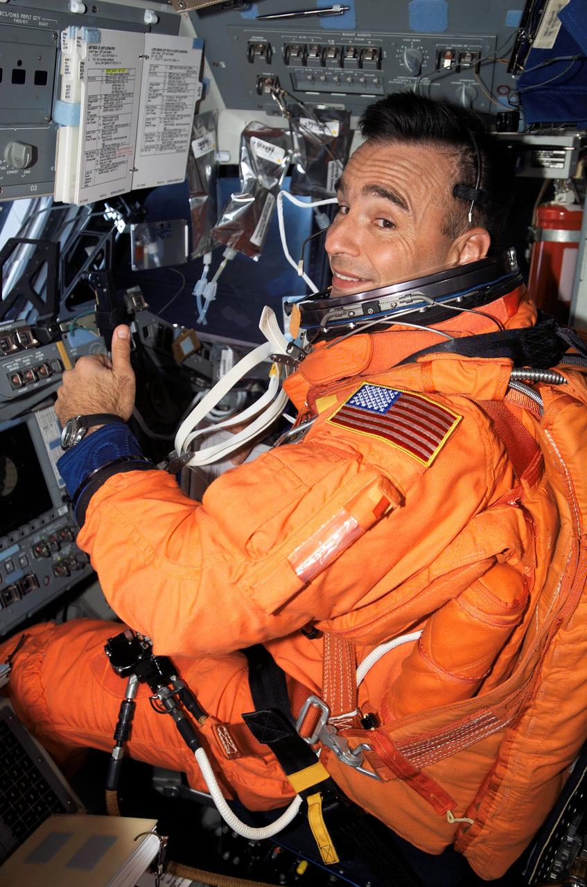 S117-E-09438 (21 June 2007) --- Attired in his launch and entry garment, astronaut Lee Archambault, STS-117 pilot, appears all ready for re-entry and landing of the Space Shuttle Atlantis, as he signals thumbs-up from the pilot's station on the starboard side of the shuttle's flight deck. Unfortunately, the weather in Florida was not ready, and the crew had to wait until the following day to land. They ultimately landed in California.