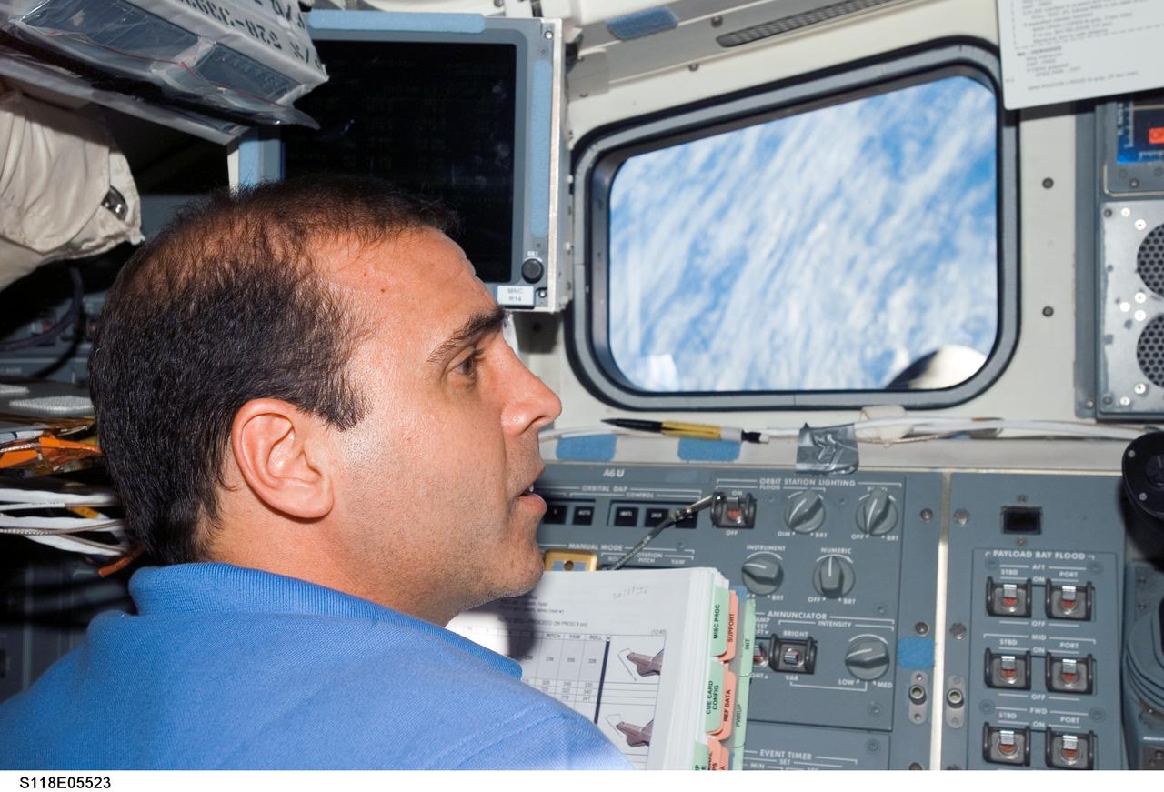 S118-E-05523 (9 Aug. 2007) --- Astronaut Rick Mastracchio, STS-118 mission specialist, works near the control panel on the aft flight deck of Space Shuttle Endeavour during flight day two activities.