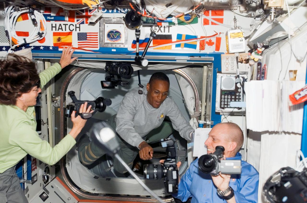 S118-E-06097 (10 Aug. 2007) --- Barbara R. Morgan, STS-118 mission specialist, participates in what looks like a photographers' convention in the Destiny lab onboard the International Space Station. Her two "fellow delegates" are astronaut Alvin Drew (center), STS-118 mission specialist, and astronaut Clay Anderson, Expedition 15 flight engineer. The photo was taken not long after the hatches were open on the orbital outpost, an action that allowed the station's population to surge from three to ten in short order.