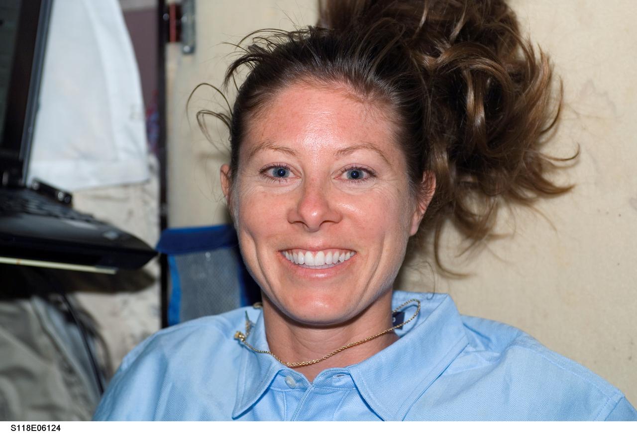 S118-E-06124 (10 Aug. 2007) --- Astronaut Tracy Caldwell, STS-118 mission specialist, smiles for a photo in the Zvezda Service Module of the International Space Station following the docking with the Space Shuttle Endeavour.