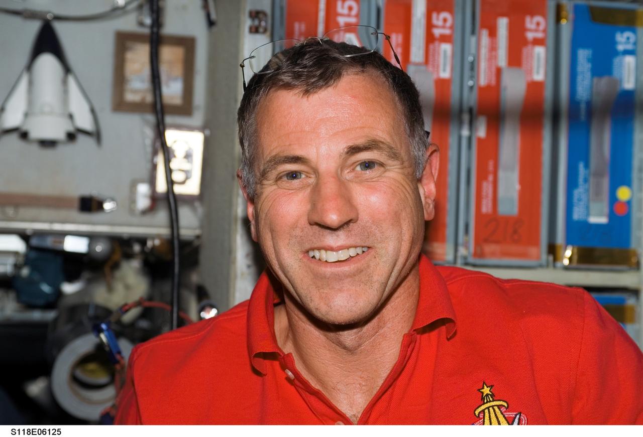 S118-E-06125 (10 Aug. 2007) --- Astronaut Dave Williams, STS-118 mission specialist representing the Canadian Space Agency, smiles for a photo in the Zvezda Service Module of the International Space Station following the docking with the Space Shuttle Endeavour.