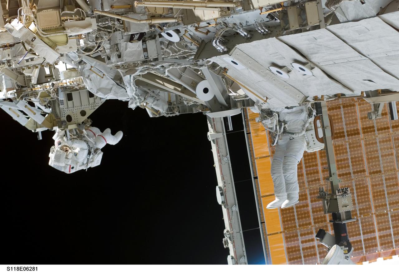 S118-E-06281 (11 Aug. 2007) --- Astronauts Rick Mastracchio (left) and Canadian Space Agency's Dave Williams, both STS-118 mission specialists, participate in the mission's first planned session of extravehicular activity (EVA), as construction continues on the International Space Station. During the 6-hour, 17-minute spacewalk Mastracchio and Williams attached the Starboard 5 (S5) segment of the station's truss, retracted the forward heat-rejecting radiator from the station's Port 6 (P6) truss, and performed several get-ahead tasks.