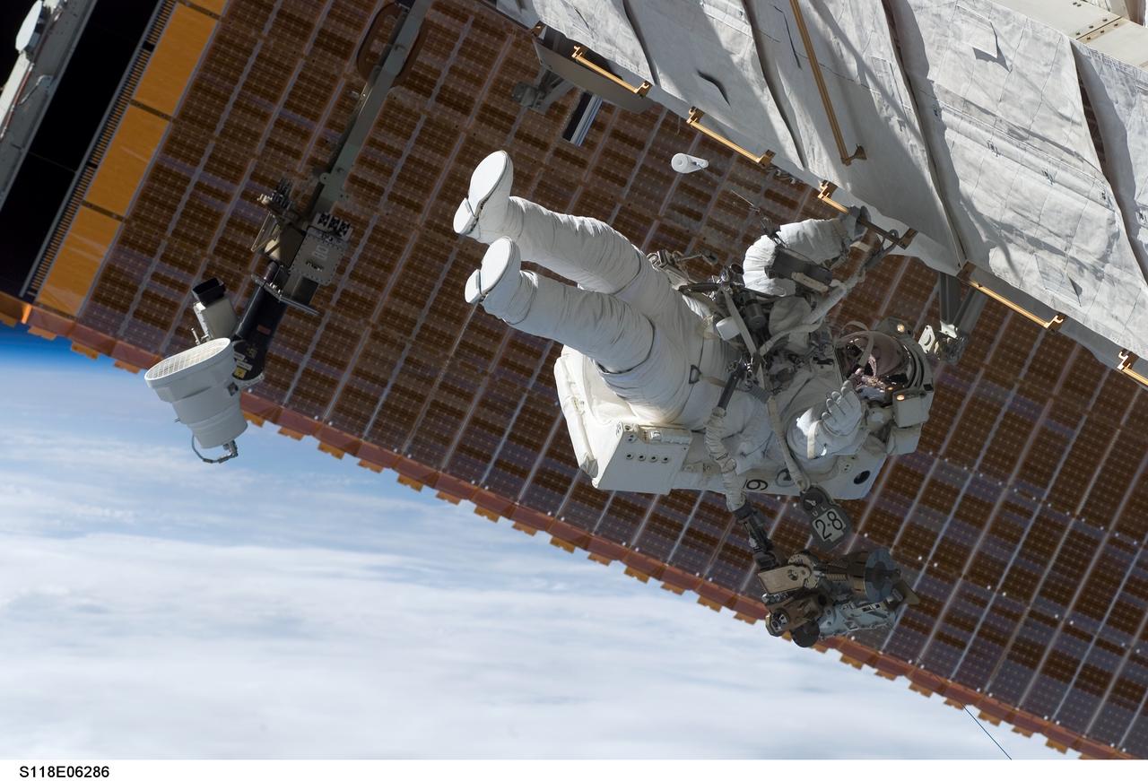 S118-E-06286 (11 Aug. 2007) --- Astronaut Dave Williams, STS-118 mission specialist representing the Canadian Space Agency, participates in the mission's first planned session of extravehicular activity (EVA), as construction continues on the International Space Station. During the 6-hour, 17-minute spacewalk, Williams and astronaut Rick Mastracchio (out of frame), mission specialist, attached the Starboard 5 (S5) segment of the station's truss, retracted the forward heat-rejecting radiator from the station's Port 6 (P6) truss, and performed several get-ahead tasks.