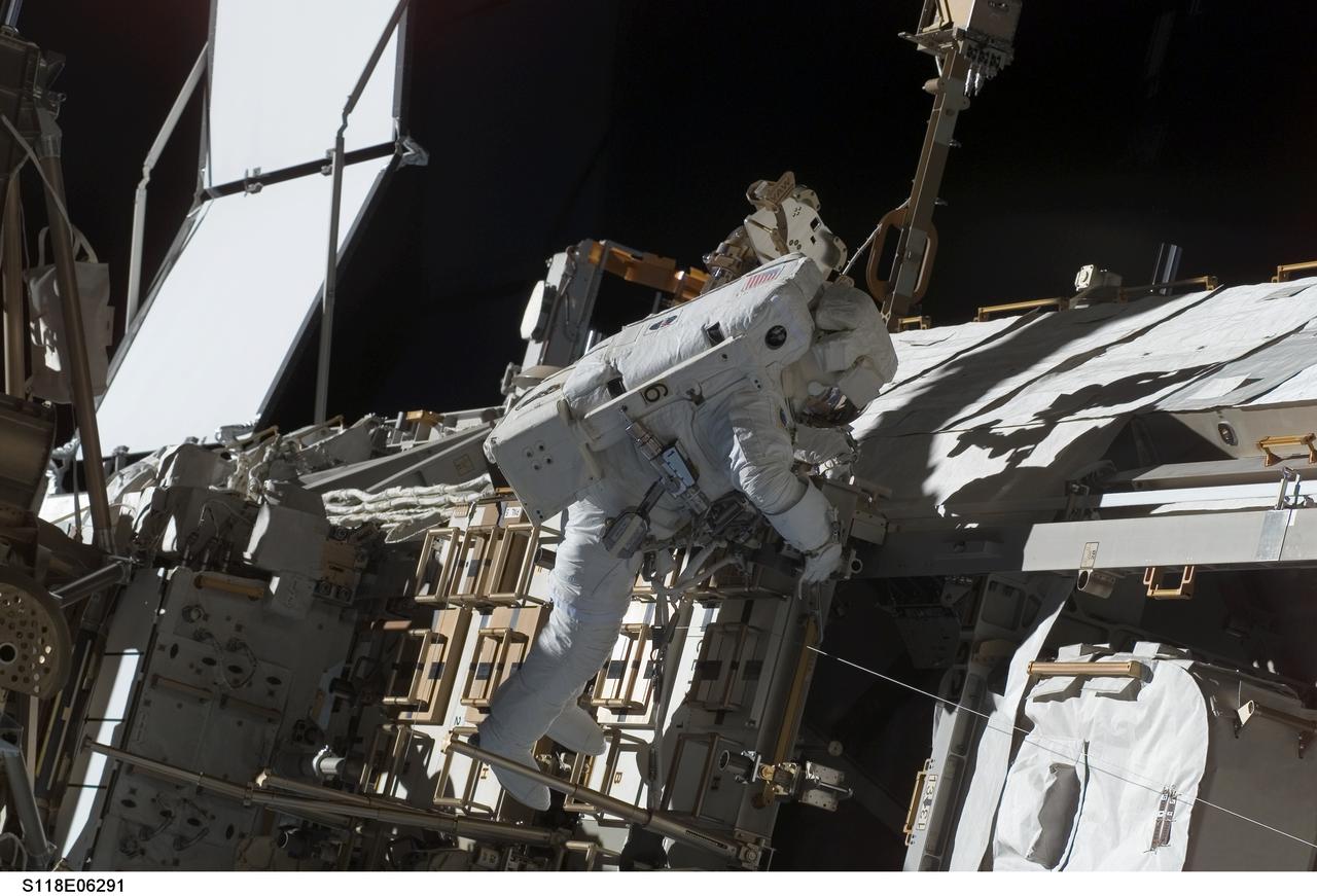 S118-E-06291 (11 Aug. 2007) --- Astronaut Dave Williams, STS-118 mission specialist representing the Canadian Space Agency, participates in the mission's first planned session of extravehicular activity (EVA), as construction continues on the International Space Station. During the 6-hour, 17-minute spacewalk, Williams and astronaut Rick Mastracchio (out of frame), mission specialist, attached the Starboard 5 (S5) segment of the station's truss, retracted the forward heat-rejecting radiator from the station's Port 6 (P6) truss, and performed several get-ahead tasks.