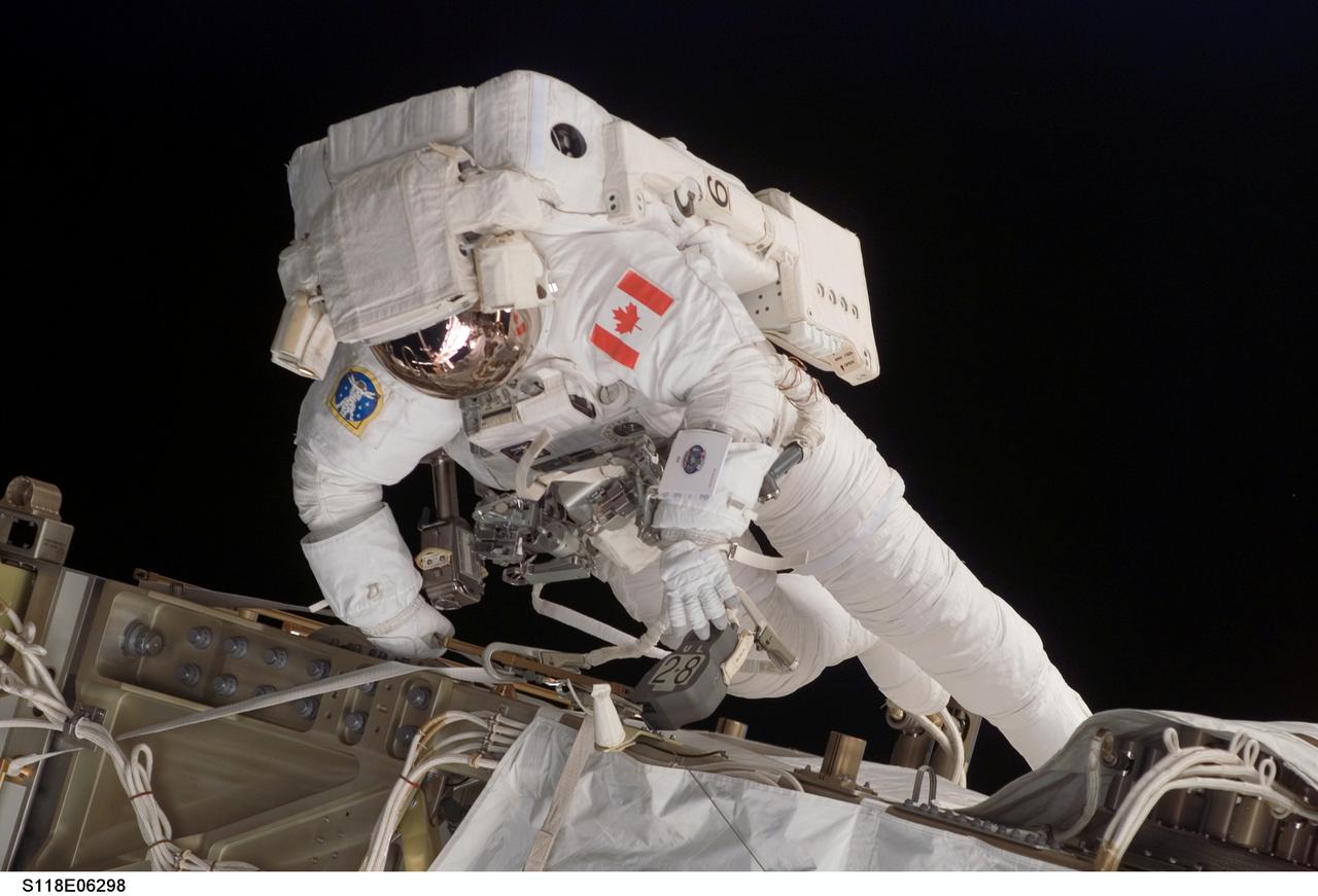 S118-E-06298 (11 Aug. 2007) --- Astronaut Dave Williams, STS-118 mission specialist representing the Canadian Space Agency, participates in the mission's first planned session of extravehicular activity (EVA), as construction continues on the International Space Station. During the 6-hour, 17-minute spacewalk, Williams and astronaut Rick Mastracchio (out of frame), mission specialist, attached the Starboard 5 (S5) segment of the station's truss, retracted the forward heat-rejecting radiator from the station's Port 6 (P6) truss, and performed several get-ahead tasks.