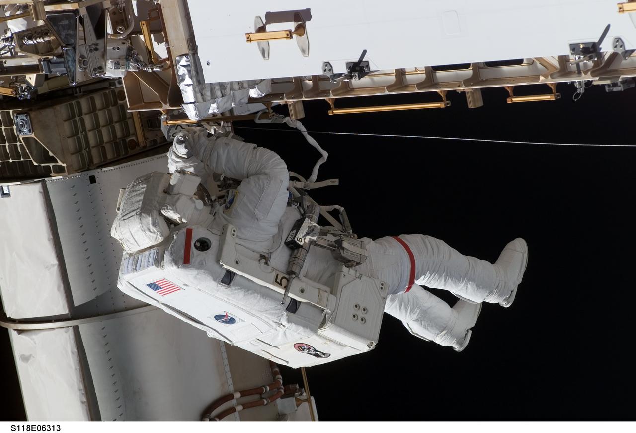 S118-E-06313 (11 Aug. 2007) --- Astronauts Rick Mastracchio and Canadian Space Agency's Dave Williams (out of frame), both STS-118 mission specialists, participate in the mission's first planned session of extravehicular activity (EVA), as construction continues on the International Space Station. During the 6-hour, 17-minute spacewalk Mastracchio and Williams attached the Starboard 5 (S5) segment of the station's truss, retracted the forward heat-rejecting radiator from the station's Port 6 (P6) truss, and performed several get-ahead tasks.