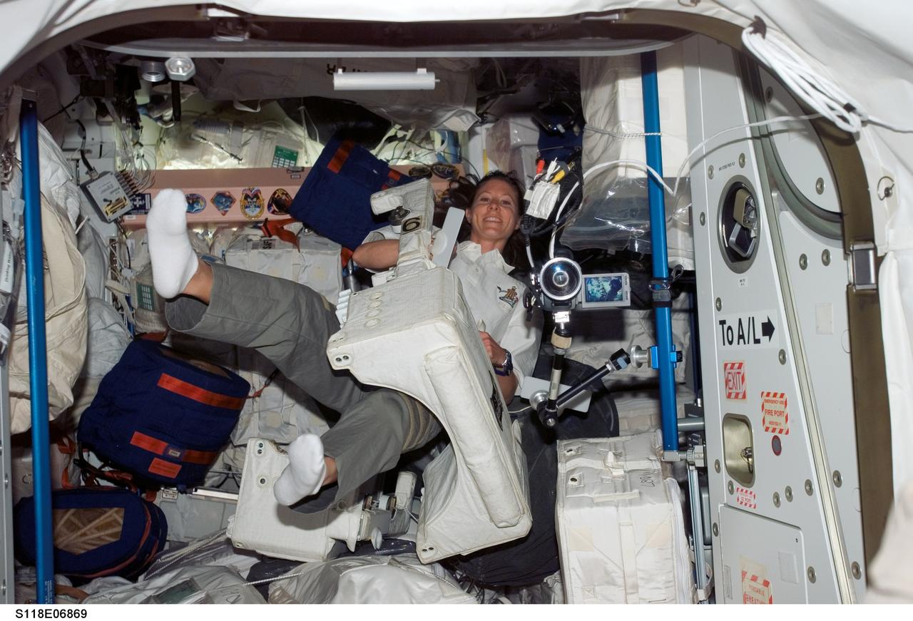 S118-E-06869 (11 Aug. 2007) --- Astronaut Tracy Caldwell, STS-118 mission specialist, floats in the Unity node of the International Space Station while Space Shuttle Endeavour remains docked with the station.