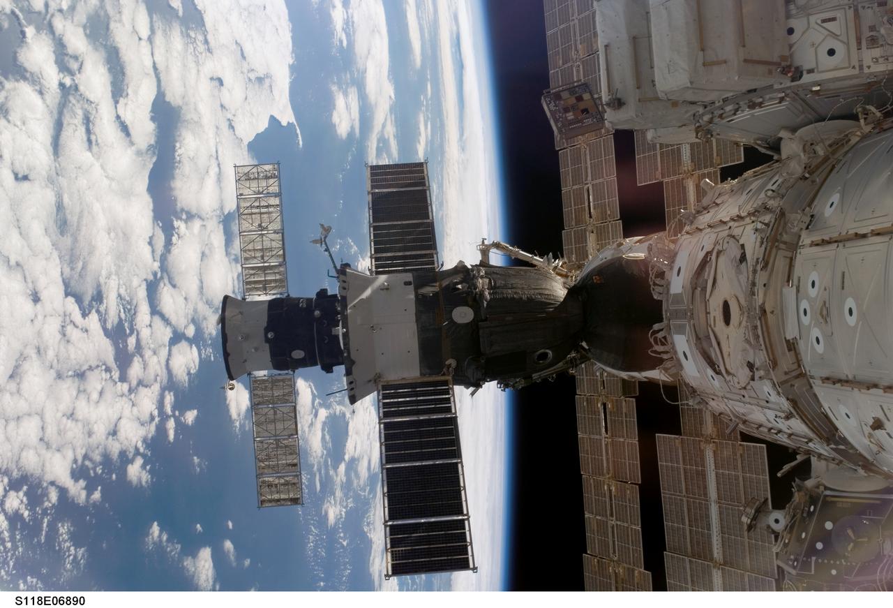 S118-E-06890 (12 Aug. 2007) --- The docked Soyuz 14 (TMA-10) (foreground) and Progress 26 resupply vehicle are featured in this image photographed by a STS-118 crewmember from a window on the International Space Station while Space Shuttle Endeavour remains docked with the station. The blackness of space and a blue and white Earth provide the backdrop for the scene.