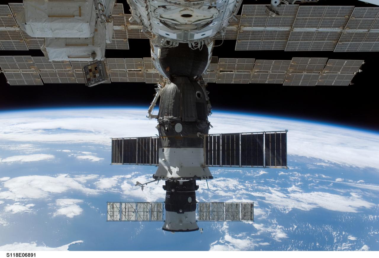 S118-E-06891 (12 Aug. 2007) --- The docked Soyuz 14 (TMA-10) (foreground) and Progress 26 resupply vehicle are featured in this image photographed by a STS-118 crewmember from a window on the International Space Station while Space Shuttle Endeavour remains docked with the station. The blackness of space and a blue and white Earth provide the backdrop for the scene.
