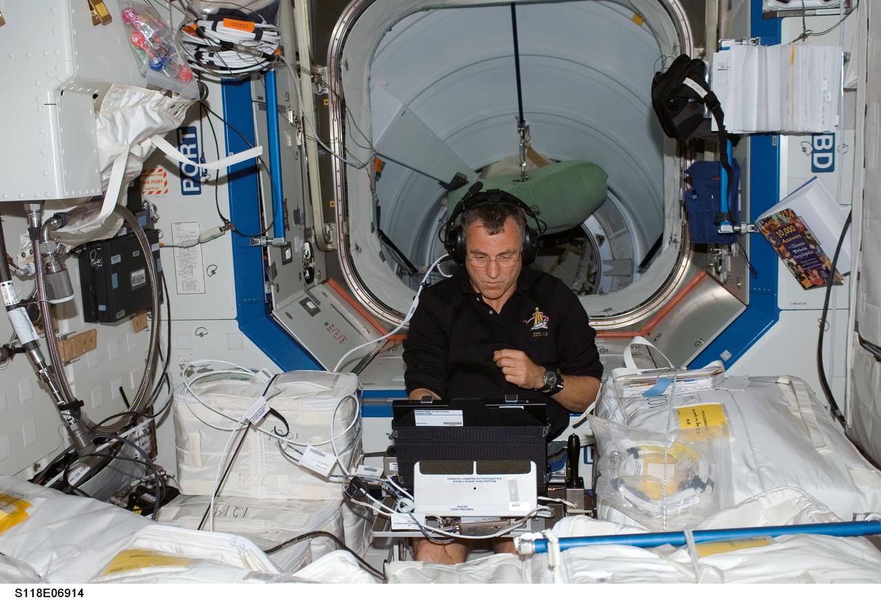 S118-E-06914 (12 Aug. 2007) --- Astronaut Dave Williams, STS-118 mission specialist representing the Canadian Space Agency, works with the Perceptual Motor Deficits in Space (PMDIS) experiment in the Destiny laboratory of the International Space Station. The PMDIS experiment will measure the decline in hand-eye coordination of shuttle astronauts while on orbit. These measurements will be used to evaluate various mechanisms thought to be responsible for the decline.
