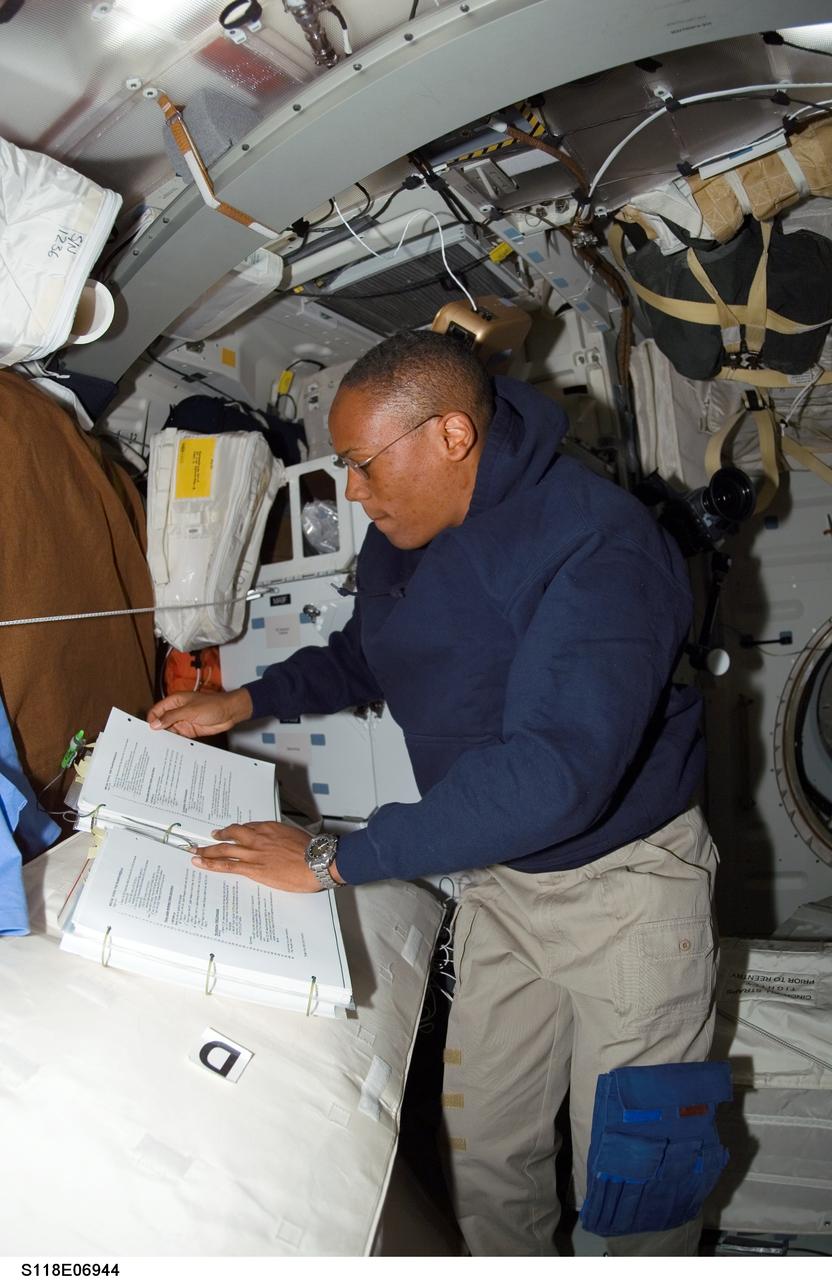 S118-E-06944 (12 Aug. 2007) --- Astronaut Alvin Drew, STS-118 mission specialist, works on the middeck of Space Shuttle Endeavour while docked with the International Space Station during flight day five activities.