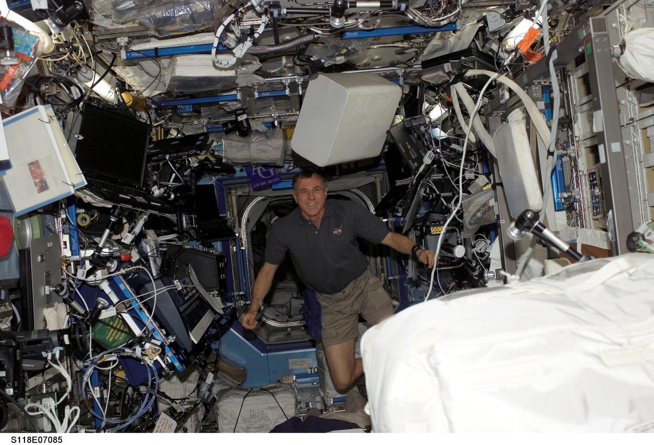 S118-E-07085 (14 Aug. 2007) --- Astronaut Dave Williams, STS-118 mission specialist representing the Canadian Space Agency, floats in the Destiny laboratory of the International Space Station while Space Shuttle Endeavour remains docked with the station.