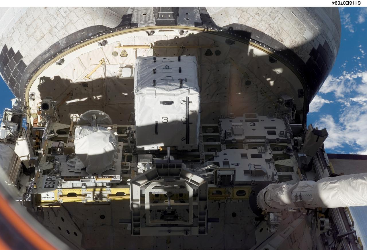 S118-E-07094 (14 Aug. 2007) --- An external stowage platform (ESP-3) is photographed in the payload bay of Space Shuttle Endeavour while docked with the International Space Station. Astronauts Tracy Caldwell and Barbara R. Morgan, both STS-118 mission specialists, were inside at Endeavour's controls as the shuttle's robotic arm (lower right) lifted the storage platform from the cargo bay to hand it over to the station's robotic arm, also known as Canadarm2. Astronauts Charlie Hobaugh, pilot, and Clay Anderson, Expedition 15 flight engineer, then used Canadarm2 to attach the 13-by-7-foot platform to the station's Port 3 truss.