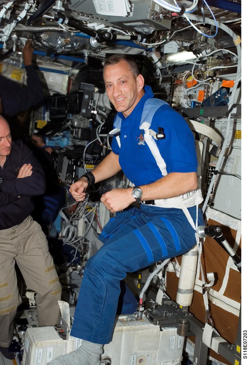S118-E-07203 (14 Aug. 2007) --- Astronaut Charlie Hobaugh, STS-118 pilot, exercises on the Cycle Ergometer with Vibration Isolation System (CEVIS) in the Destiny laboratory of the International Space Station while Space Shuttle Endeavour remains docked with the station. Astronaut Scott Kelly, commander, is partially visible at left edge of frame.