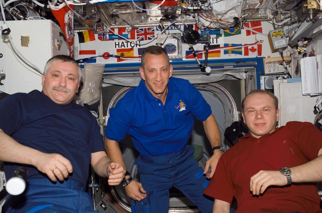 S118-E-07205 (14 Aug. 2007) --- Cosmonauts Fyodor N. Yurchikhin (left) and Oleg V. Kotov (right), Expedition 15 commander and flight engineer, respectively, representing Russia's Federal Space Agency; and astronaut Charlie Hobaugh, STS-118 pilot, pose for a photo in the Destiny laboratory of the International Space Station while Space Shuttle Endeavour remains docked with the station.