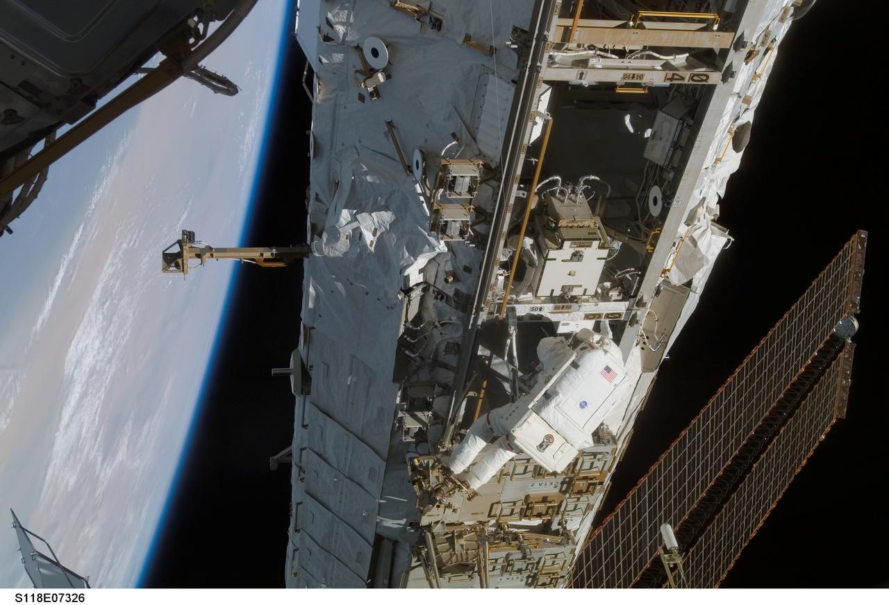 S118-E-07326 (15 Aug. 2007) --- Astronaut Clay Anderson, Expedition 15 flight engineer, participates in the mission's third planned session of extravehicular activity (EVA) as construction and maintenance continue on the International Space Station. During the 5-hour, 28-minute spacewalk, Anderson and astronaut Rick Mastracchio (out of frame), STS-118 mission specialist, relocated the S-Band Antenna Sub-Assembly from Port 6 (P6) to Port 1 (P1) truss, installed a new transponder on P1 and retrieved the P6 transponder. The blackness of space and Earth's horizon provide the backdrop for the scene.