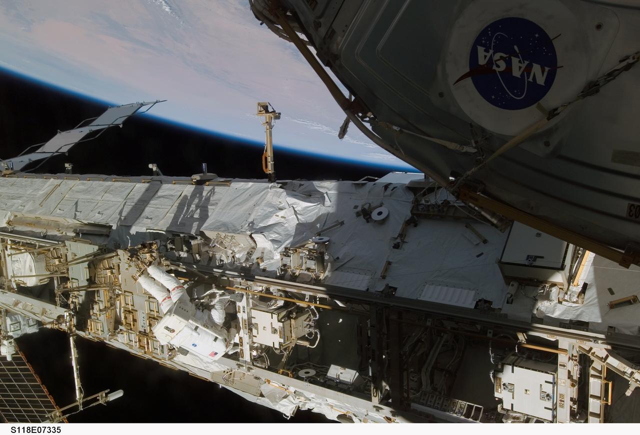 S118-E-07335 (15 Aug. 2007) --- Astronaut Clay Anderson, Expedition 15 flight engineer, participates in the mission's third planned session of extravehicular activity (EVA) as construction and maintenance continue on the International Space Station. During the 5-hour, 28-minute spacewalk, Anderson and astronaut Rick Mastracchio (out of frame), STS-118 mission specialist, relocated the S-Band Antenna Sub-Assembly from Port 6 (P6) to Port 1 (P1) truss, installed a new transponder on P1 and retrieved the P6 transponder. The blackness of space and Earth's horizon provide the backdrop for the scene.