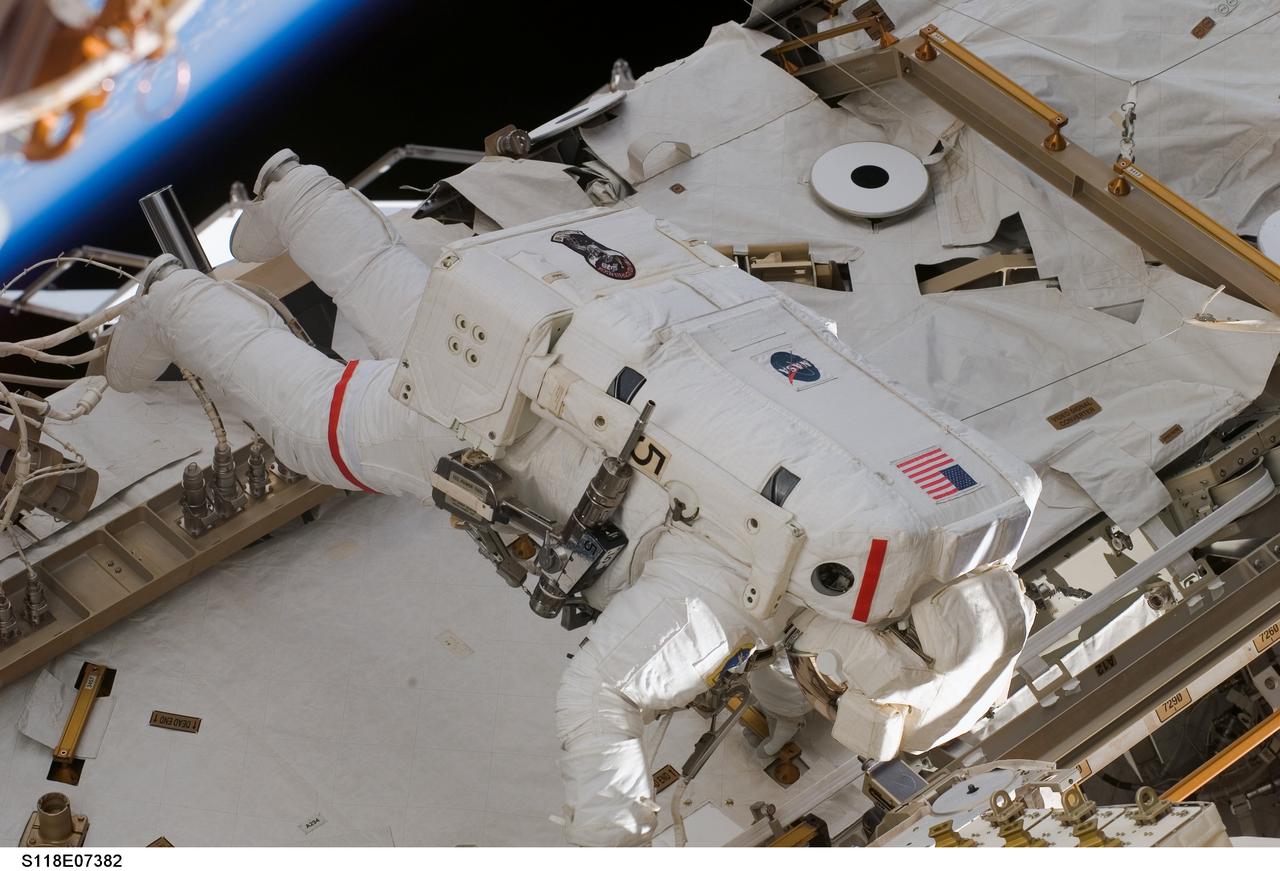 S118-E-07382 (15 Aug. 2007) --- Astronaut Rick Mastracchio, STS-118 mission specialist, participates in the mission's third planned session of extravehicular activity (EVA) as construction and maintenance continue on the International Space Station. During the 5-hour, 28-minute spacewalk, Mastracchio and astronaut Clay Anderson (out of frame), Expedition 15 flight engineer, relocated the S-Band Antenna Sub-Assembly from Port 6 (P6) to Port 1 (P1) truss, installed a new transponder on P1 and retrieved the P6 transponder.
