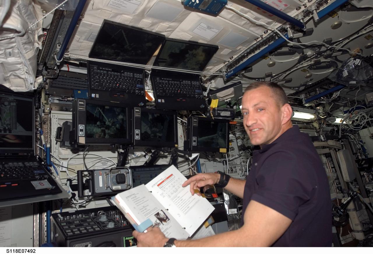 S118-E-07492 (13 Aug. 2007) Astronaut Charlie Hobaugh, STS-118 pilot, at the controls for Canadarm2 in the Destiny module on the International Space Station.