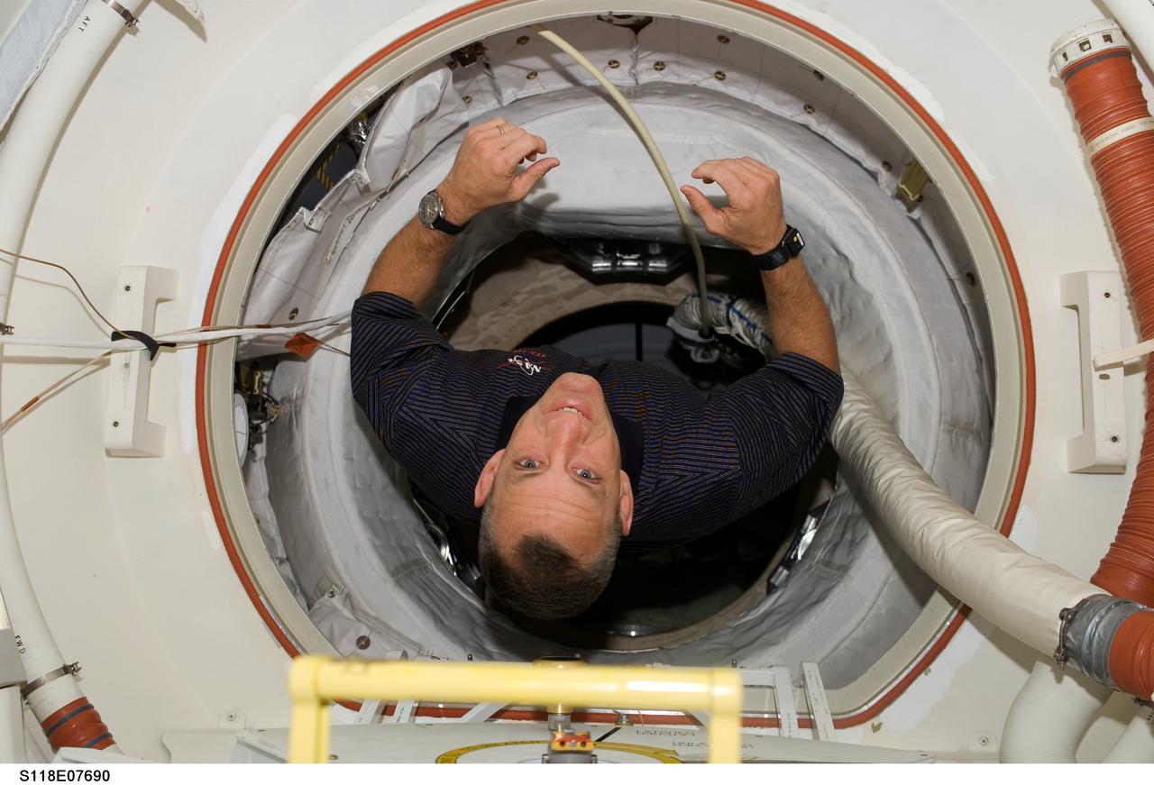 S118-E-07690 (17 Aug. 2007) --- Astronaut Charlie Hobaugh, STS-118 pilot, traverses through tunnel as the two crews of the Space Shuttle Endeavour and the International Space Station prepare for the mission's final spacewalk on the following day.