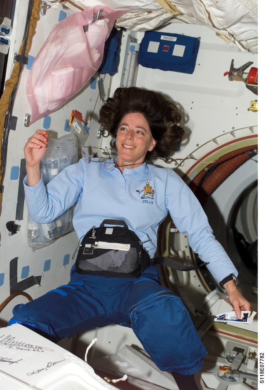 S118-E-07782 (17 Aug. 2007) --- Astronaut Barbara R. Morgan, STS-118 mission specialist, admires a cracker, cheese and meat sandwich she's put together on the mid deck of the Space Shuttle Endeavour. Morgan and her six crewmates are heading down to their final days in joint operations with the Expedition 15 crewmembers on the International Space Station.