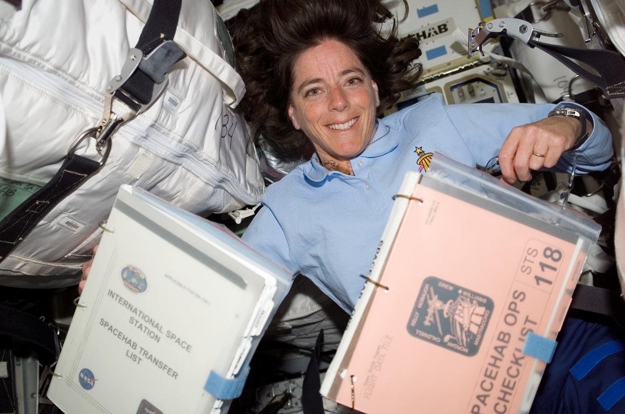 S118-E-07813 (17 Aug. 2007) --- Astronaut Barbara R. Morgan, mission specialist, is surrounded by supplies in SPACEHAB, located in the cargo bay of the Space Shuttle Endeavour. Supply transfer was one of the main activities on the agenda Aug. 17 for the STS-118 crewmembers, who learned their anticipated departure from the International Space Station will come a day earlier due to possible weather issues back home.