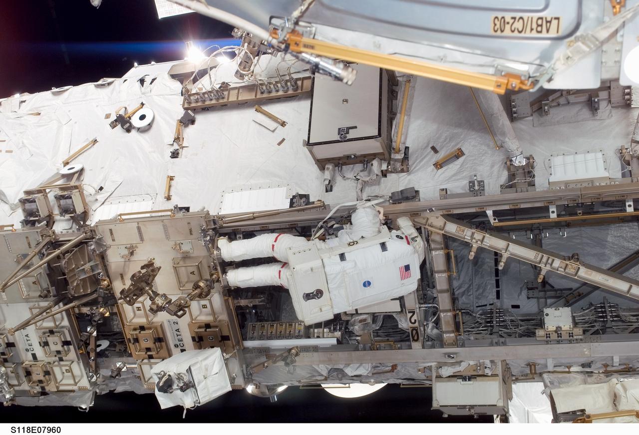 S118-E-07960 (15 Aug. 2007) --- Astronaut Clay Anderson, Expedition 15 flight engineer, participates in the mission's third planned session of extravehicular activity (EVA) as construction and maintenance continue on the International Space Station. During the 5-hour, 28-minute spacewalk, Anderson and astronaut Rick Mastracchio (out of frame), STS-118 mission specialist, relocated the S-Band Antenna Sub-Assembly from Port 6 (P6) to Port 1 (P1) truss, installed a new transponder on P1 and retrieved the P6 transponder.