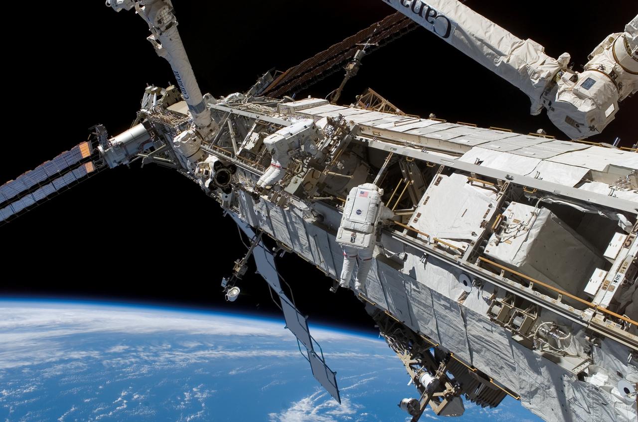 S118-E-07997 (15 Aug. 2007) --- Astronauts Rick Mastracchio (right), STS-118 mission specialist; and Clay Anderson, Expedition 15 flight engineer, participate in the mission's third planned session of extravehicular activity (EVA) as construction and maintenance continue on the International Space Station. During the 5-hour, 28-minute spacewalk, Mastracchio and Anderson relocated the S-Band Antenna Sub-Assembly from Port 6 (P6) to Port 1 (P1) truss, installed a new transponder on P1 and retrieved the P6 transponder. The blackness of space and Earth's horizon provide the backdrop for the scene.