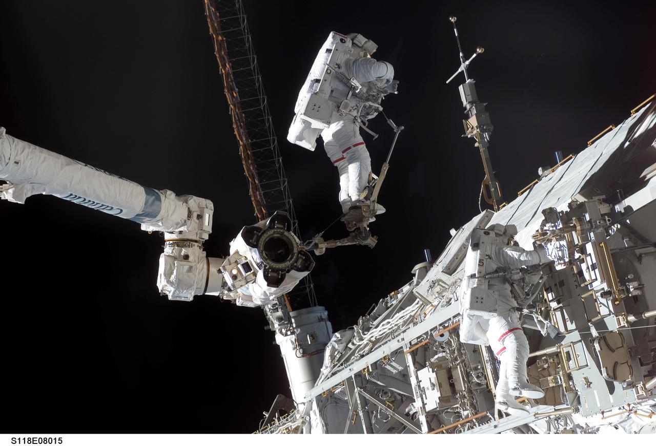S118-E-08015 (15 Aug. 2007) --- Astronauts Rick Mastracchio (right), STS-118 mission specialist; and Clay Anderson (anchored to the foot restraint on the Canadarm2), Expedition 15 flight engineer, participate in the mission's third planned session of extravehicular activity (EVA) as construction and maintenance continue on the International Space Station. During the 5-hour, 28-minute spacewalk, Mastracchio and Anderson relocated the S-Band Antenna Sub-Assembly from Port 6 (P6) to Port 1 (P1) truss, installed a new transponder on P1 and retrieved the P6 transponder.