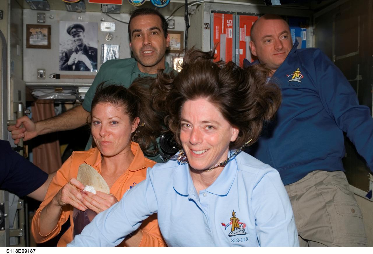 S118-E-09187 (18 Aug. 2007) --- The STS-118 and Expedition 15 crews gather for a farewell ceremony in the Zvezda Service Module of the International Space Station. Pictured are astronauts Barbara R. Morgan (foreground), Tracy Caldwell (left) and Rick Mastracchio, all STS-118 mission specialists; along with Scott Kelly (right), STS-118 commander. Hatches were closed between the station and Space Shuttle Endeavour at 4:10 p.m. on Aug. 18.