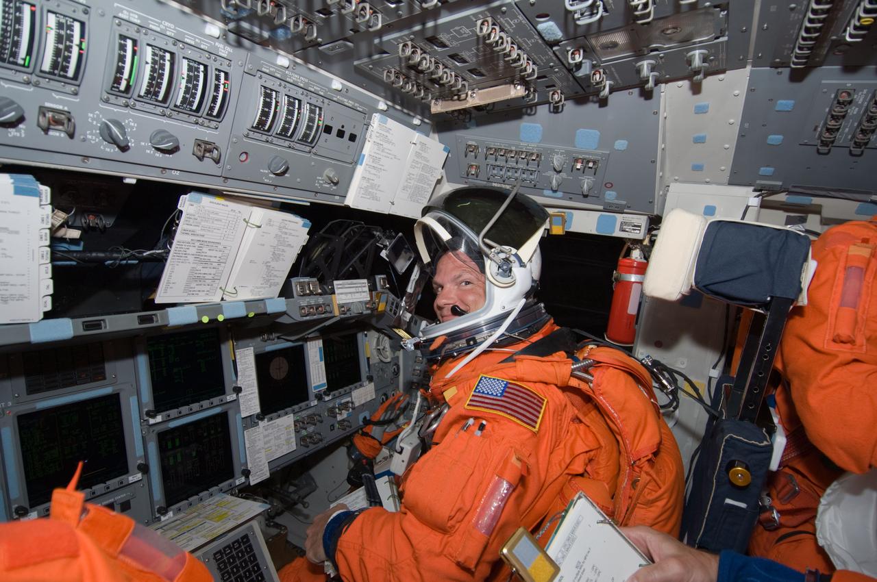 S119-E-005008 (15 March 2009) --- Astronaut Tony Antonelli, STS-119 pilot, attired in his shuttle launch and entry suit, takes a moment for a photo while occupying the pilot's station on the flight deck of Space Shuttle Discovery during postlaunch activities.