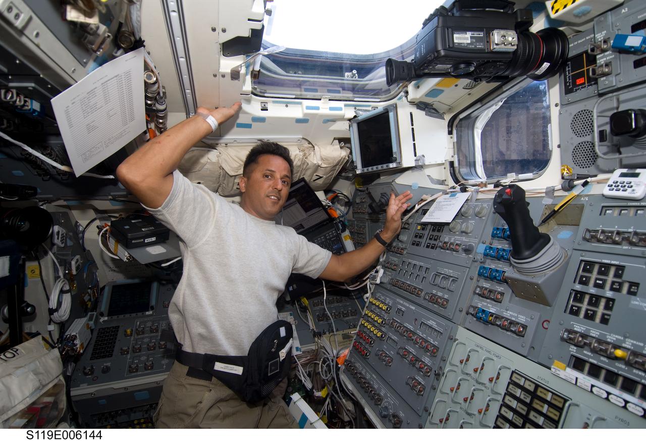 S119-E-006144 (16 March 2009) --- Astronaut Joseph Acaba, STS-119 mission specialist, works on the aft flight deck of Space Shuttle Discovery during flight day two activities.