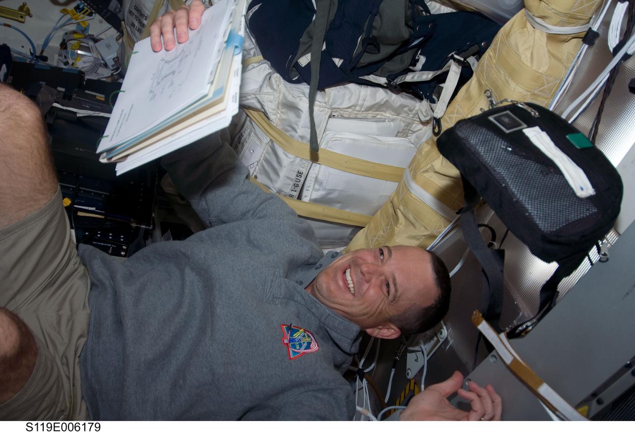 S119-E-006179 (16 March 2009) --- Astronaut Richard Arnold, STS-119 mission specialist, enjoys a light moment while working on the middeck of Space Shuttle Discovery during flight day two activities.